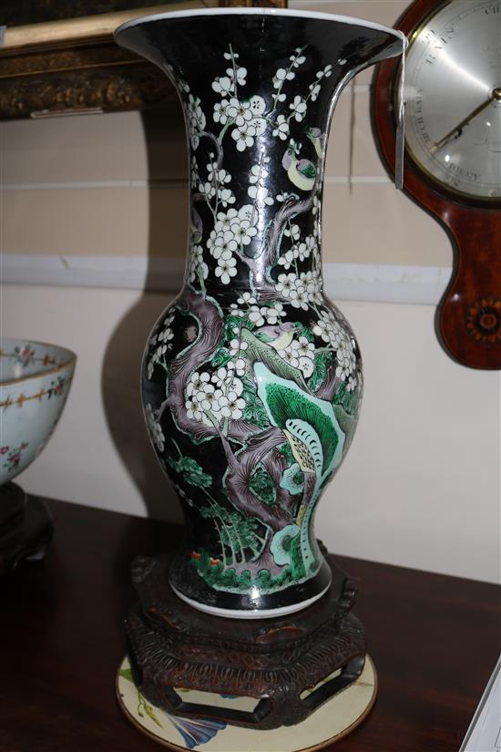 A Chinese famille noir long-necked baluster vase on stand